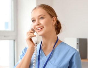 dental team member smiling on the phone